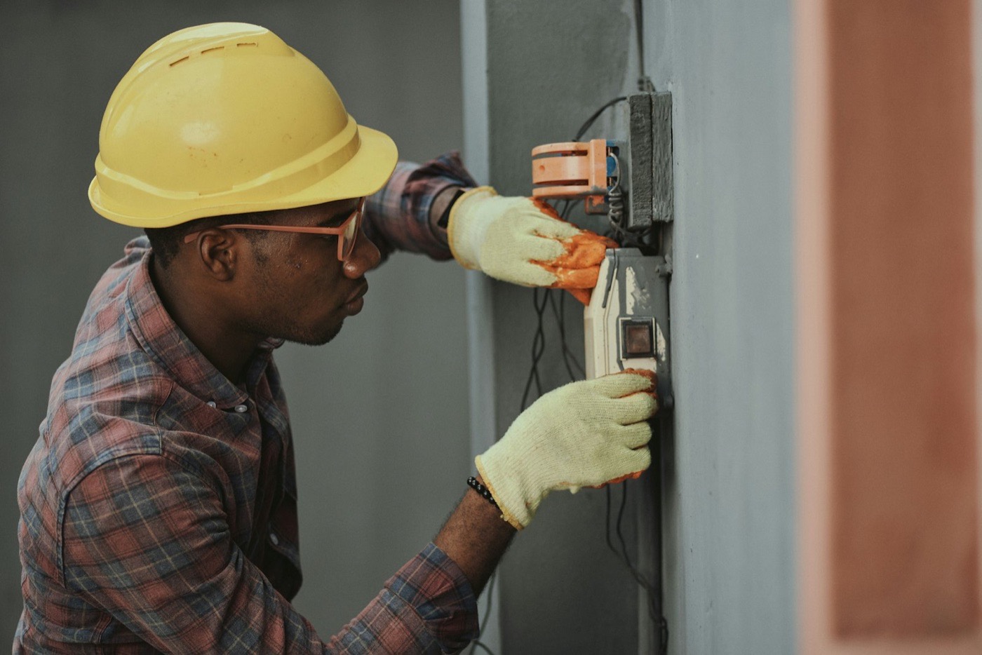 Licensed electrician installing a circuit breaker panel